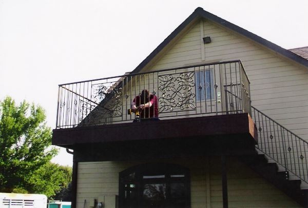 Hand-forged iron staircase railing with straight pickets in a Nampa, Idaho home