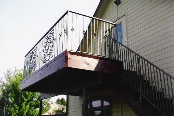 Wrought iron staircase railing with a hand-forged newel post in Nampa, Idaho