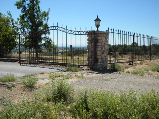 Custom arched wrought iron garden gate hand-forged by Anvil Iron Works in Nampa, Idaho